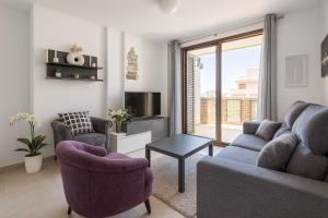 a living room with a couch and two chairs and a tv at 3 bedroom, two-level, morden apartment in Orihuela Costa