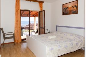 a bedroom with a bed and a view of the ocean at Vila petra in Prizba +57 photos