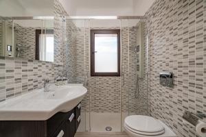 a bathroom with a sink and a toilet and a shower at Estay - Locanda Tartarughino in Porto Rotondo
