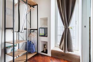 a living room with a staircase and a window at Tresor 39 in Polignano a Mare