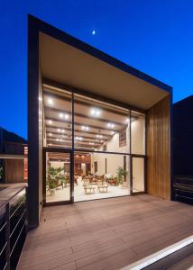 a house with glass doors and a deck at night at Terrace Midoubaru in Beppu