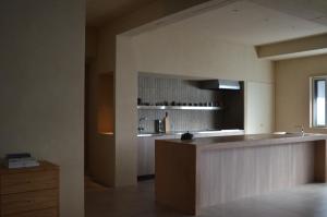 a large kitchen with a counter and a sink at 雲居月-kumoizuki- in Ginowan