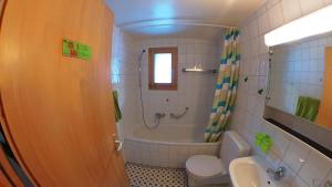 Un baño con bañera, inodoro y lavabo. en Doberts 6, un duplex au pied des montagnes!, en Zinal 10 fotos más