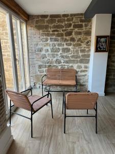 two chairs and a table in front of a brick wall at Plus in Logroño