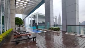 a view of a building with benches on the floor at The Platinum Kuala Lumpur by MAHA in Kuala Lumpur