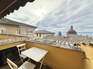 a balcony with two chairs and a table on a roof at La terrazza su Assisi in Assisi