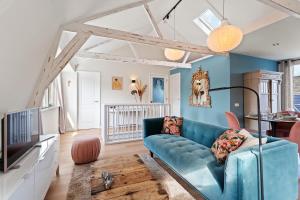 een woonkamer met een blauwe bank bij Abcoude city center in Abcoude