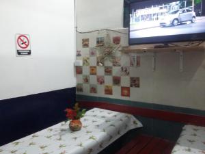 Una cama o camas en una habitación de Hospedaje La Rana