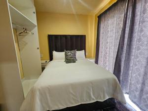 Ένα ή περισσότερα κρεβάτια σε δωμάτιο στο Sunrise Guest house