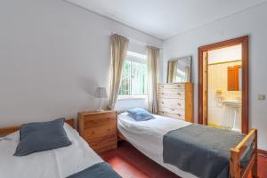 En eller flere senge i et værelse på Moradia Milú frente à praia