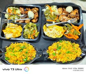 a bunch of food in trays on a table at Vilaasitaa Family Suites in Indore +16 photos