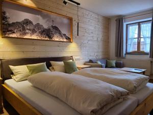 OberostendorfLandgasthof Wangerstuben的带两张床和一张沙发的卧室