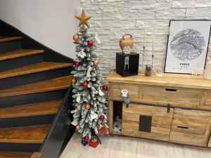 a christmas tree in a living room with a staircase at Love House - Maison entière et son jardin - Rare à Paris in Paris