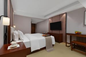 Postel nebo postele na pokoji v ubytování Qinzhu Hotel