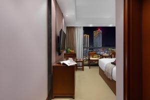 Postel nebo postele na pokoji v ubytování Qinzhu Hotel