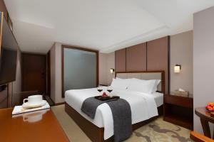 Postel nebo postele na pokoji v ubytování Qinzhu Hotel