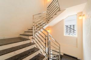 a spiral staircase in a house with a window at Treebo Gt Residency, 10 Mins To Thiruvananthapuram International Airport in Trivandrum