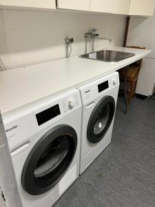 a kitchen with a washing machine and a sink at Villa Älva i Sälen in Sälen