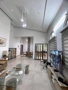 a large living room with a large flat screen tv at Appartement de luxe avec piscine in Abomey-Calavi