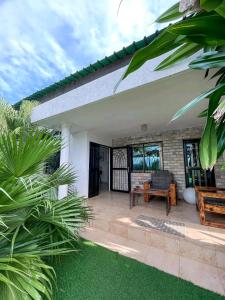 a patio of a house with a couch and a table at Appartement de luxe avec piscine in Abomey-Calavi