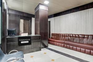 a waiting room with brown leather seats in a building at Collection O Haridwar Railway Station Formerly Le Central in Haridwār