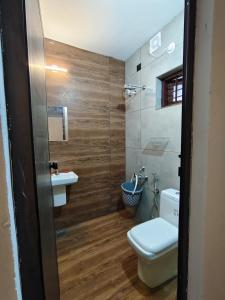 a bathroom with a toilet and a sink at Moonlit Nest in Kappil
