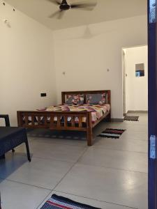 a bedroom with a wooden bed in a room at Moonlit Nest in Kappil