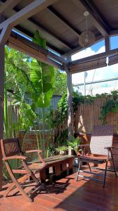 a patio with two chairs and a bench on a deck at 都蘭朋友家 Dulan Friends Hostel in Donghe