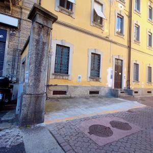 ein gelbes Gebäude mit einem Gully davor in der Unterkunft Maison Giulietta e Spa con parcheggio privato in Como