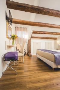 a bedroom with a bed and a table and a chair at Locanda Ca' Lucrezia in Venice