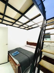 a bedroom with a bed and a staircase at Inap Indah in Kuantan