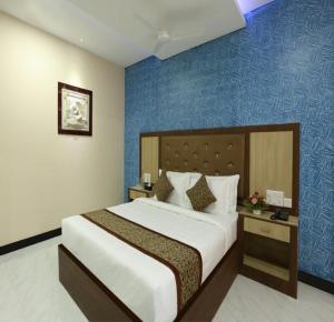 a bedroom with a large bed and a blue wall at TNV Casita Inn in Yercaud +37 photos