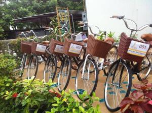 a row of bicycles parked next to each other at Goldenbell Hotel Chiangmai - SHA Extra Plus in Chiang Mai