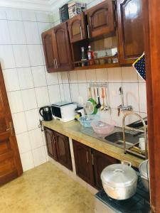 a kitchen with a sink and a counter top at MADO Appartement in Bonamoussadi +7 photos