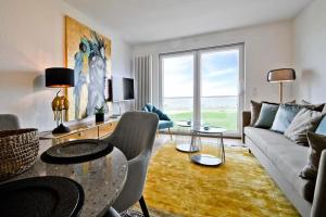 a living room with a couch and a table at Fewo Gestrandet in Norderney +1 photo