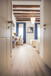 a bedroom with a bed and a desk in a room at Locanda Ca' Lucrezia in Venice