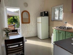 a kitchen with green cabinets and a white refrigerator at Finca Chigora nice rural house near Los Gigantes Sun Room in Santiago del Teide