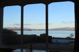 a view of a lake from a window at An Cala in Connel