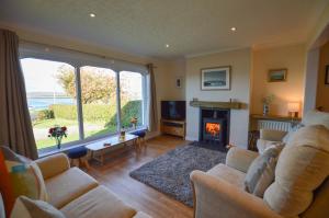 a living room with a couch and a fireplace at An Cala in Connel