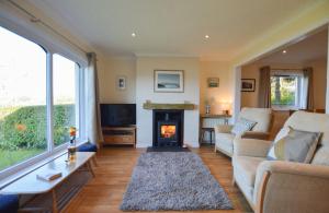 a living room with a couch and a fireplace at An Cala in Connel +38 photos