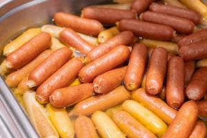 a bunch of hot dogs and other vegetables in a pan at CHECK inn Taichung Ziyou in Taichung
