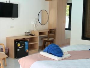 a room with a bed with a mirror and a desk at Pinky Bungalow Resort & Villa - SHA Extra Plus in Ko Lanta +14 photos