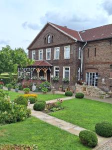 a large brick house with a garden in front of it at Bleckmanns Hof in Werne an der Lippe