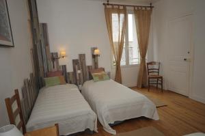 Ένα ή περισσότερα κρεβάτια σε δωμάτιο στο Les Gîtes du Château de la Viaudière