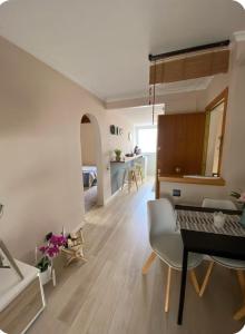 a living room with a table and a dining room at Ocean View Sunny Beach Apartment Castelldefels in Castelldefels