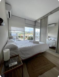 a bedroom with a large bed and a large window at Ocean View Sunny Beach Apartment Castelldefels in Castelldefels