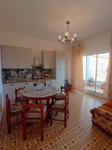 a kitchen with a table and chairs in a room at Horizon Apt in Taormina