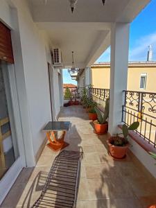 a balcony of a house with a bench and plants at Horizon Apt in Taormina