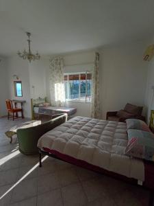 a bedroom with a large bed and a living room at Horizon Apt in Taormina