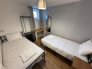 Ένα ή περισσότερα κρεβάτια σε δωμάτιο στο 3BR Flat Near Station